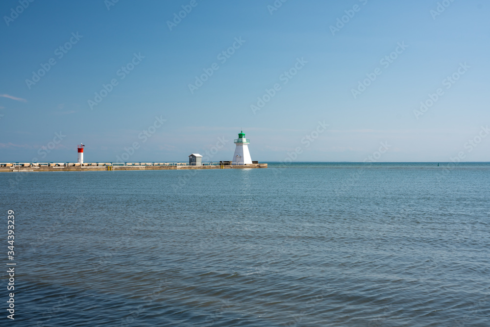 Beautiful Waterfront Landscape during clear blue skies with a lighthouse 