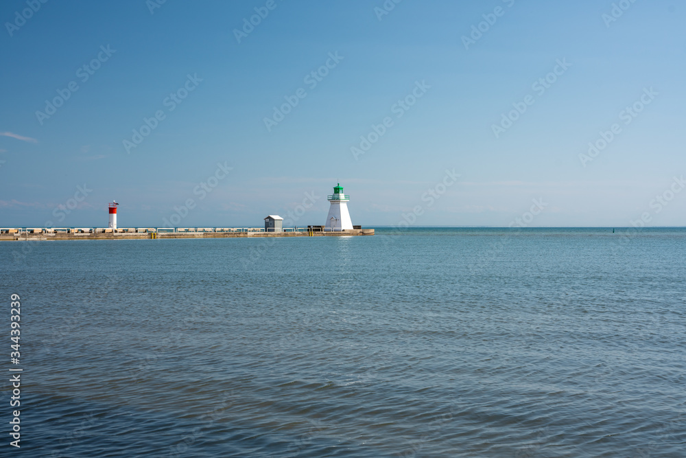 Beautiful Waterfront Landscape during clear blue skies with a lighthouse Beautiful Waterfront Landscape during clear blue skies with a lighthouse