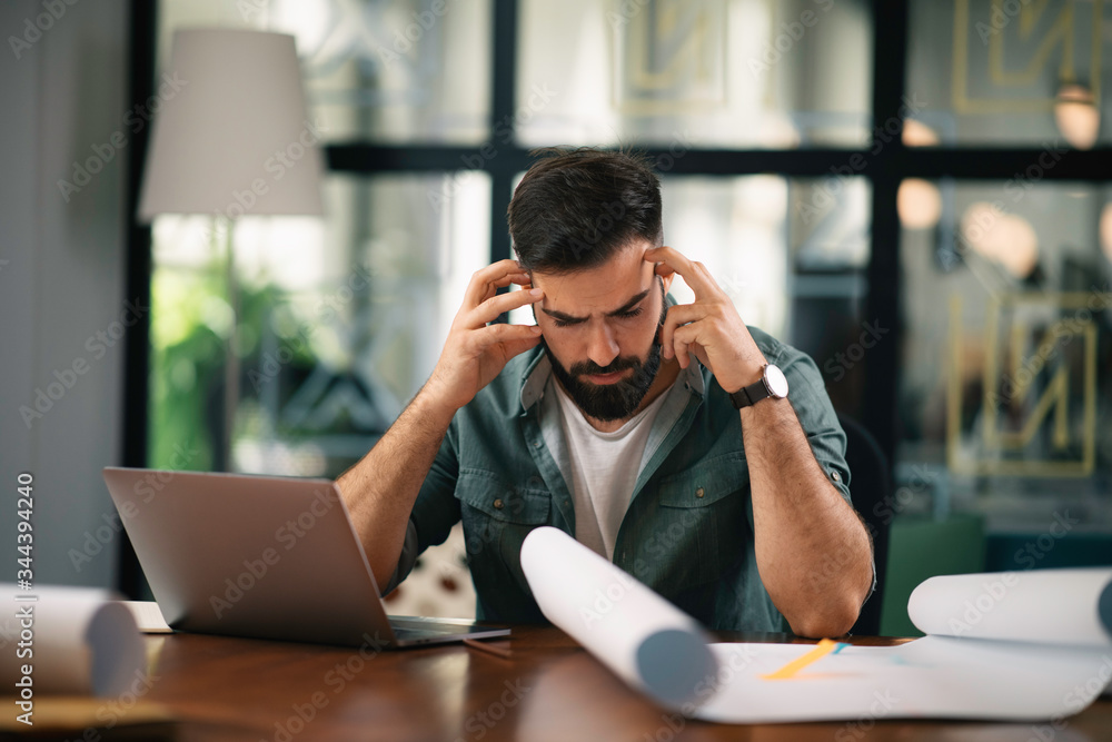 Young businessman working in office. Handsome man at work.
Young businessman working in office. Handsome man at work.
