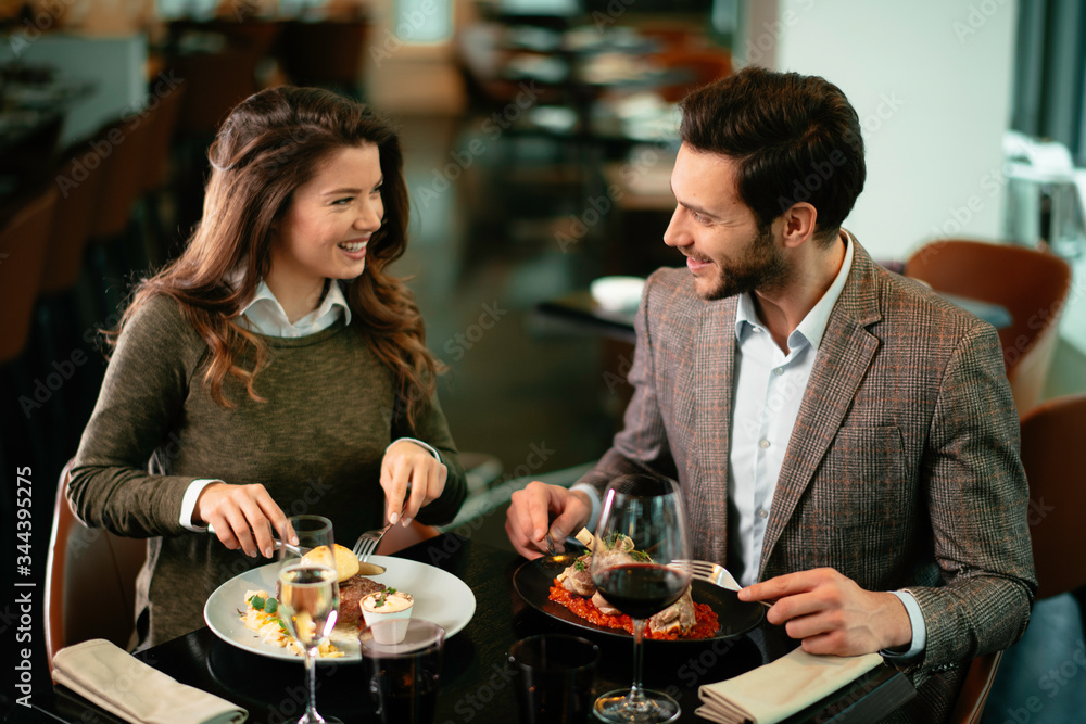 Happy loving couple enjoying in restaurant. Young couple enjoying in food. Happy loving couple enjoying in restaurant. Young couple enjoying in food.