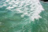 Sea texture, beautiful turquoise water waves with white foam, powerful nature concept, full frame, ocean