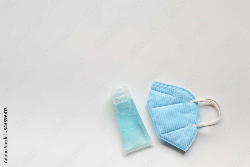 Face mask and alcohol gel on white background Face mask and alcohol gel on white background