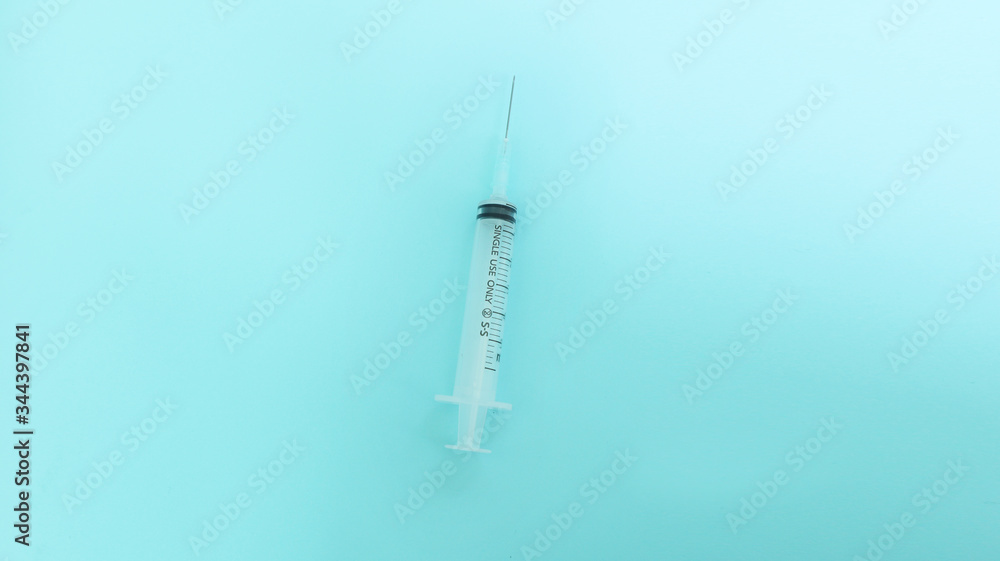 syringe on a blue background 