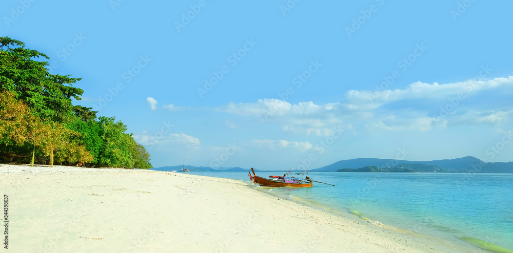 Fototapeta premium beautiful tropical landscape. Thai traditional longtail boat and sandy beach. Summer travel and sea trip vacation. copy space.