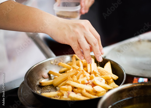 Chef is cooking french fries in the kitchen, Chef cooking fried potato