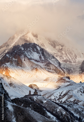 Gergeti Trinity Church, Holy Trinity Church and mount Kazbek 5,054 m high, near the village of Gergeti in Georgia.