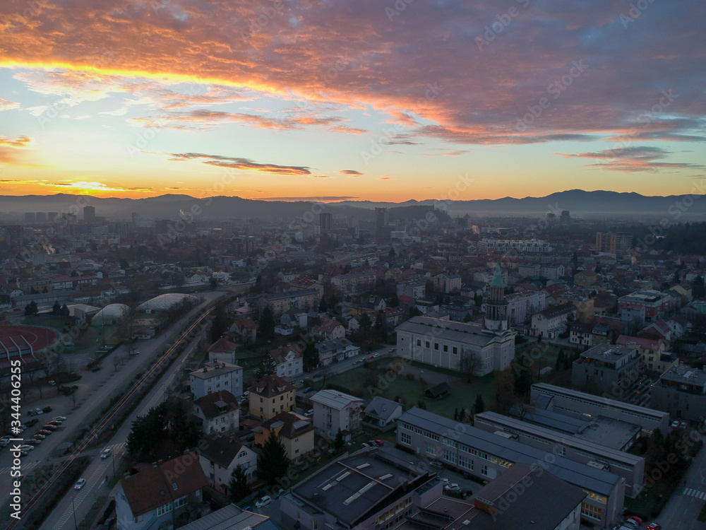 Beautiful aerial panorama of Ljubljana, Slovenia in the early morning, just around sunrise in december, with mist and fog still visible rising from the basin.. Siska suburb in the foreground.