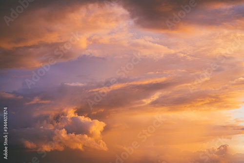Evening sunset sky with bright rays of the sun and beautiful colorful clouds © skrotov