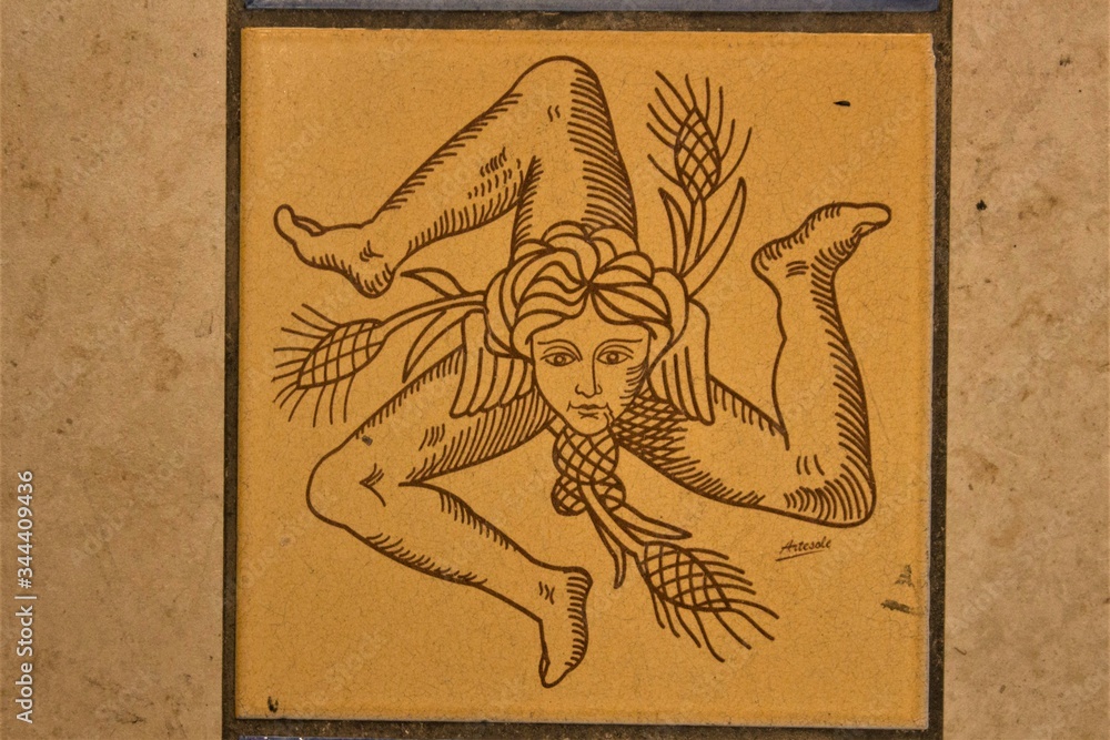 female head with three folded legs said "Trinacria" symbol of the