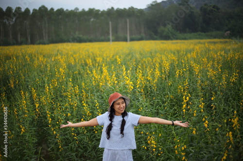 A woman standing in the crotalaria juncea field in Rayong, Thailand photo