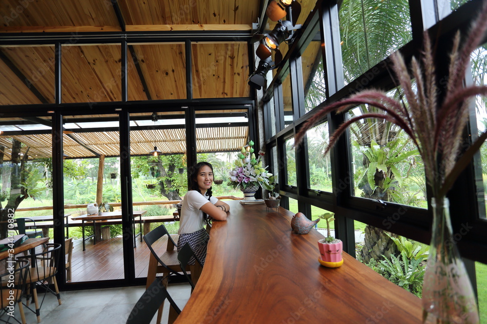 Woman sitting in a cafe in Chon Buri, Thailand