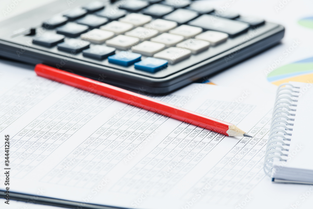 Business financial documents, office calculator and pen on the table. Numbers and graphs Business financial documents, office calculator and pen on the table. Numbers and graphs