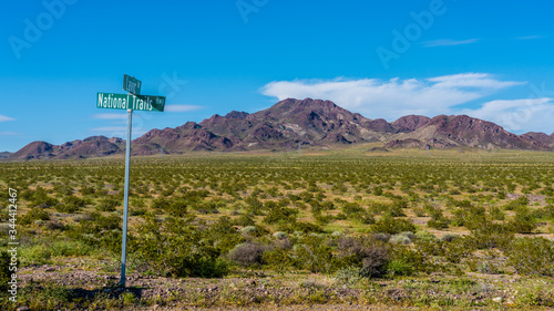 Route 66 landscape in Mojave desert with national Trails sign post. 