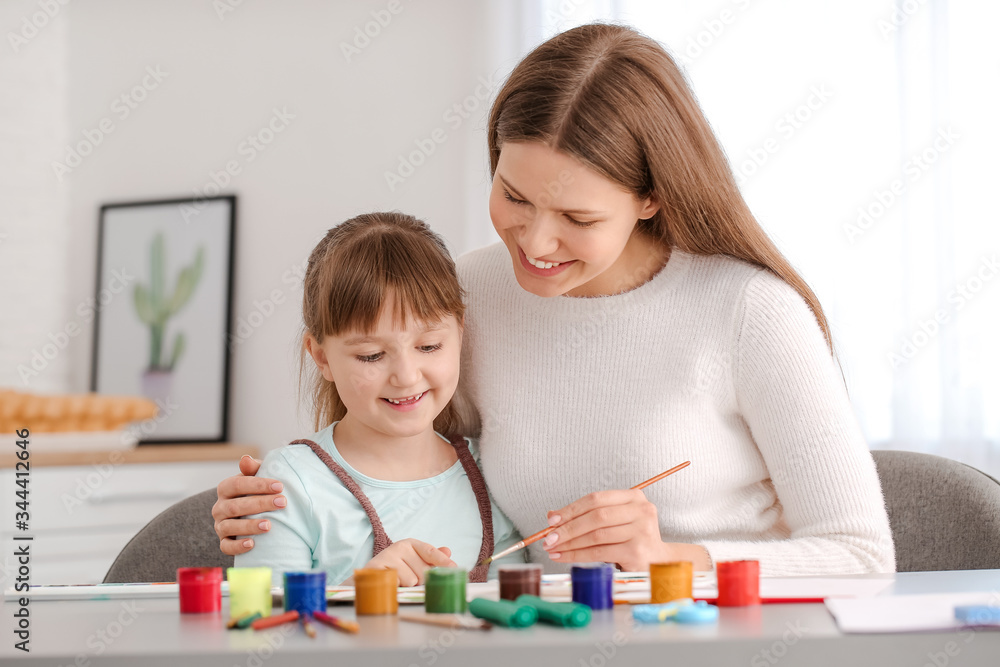 Drawing teacher giving private art lessons to little girl at home Drawing teacher giving private art lessons to little girl at home