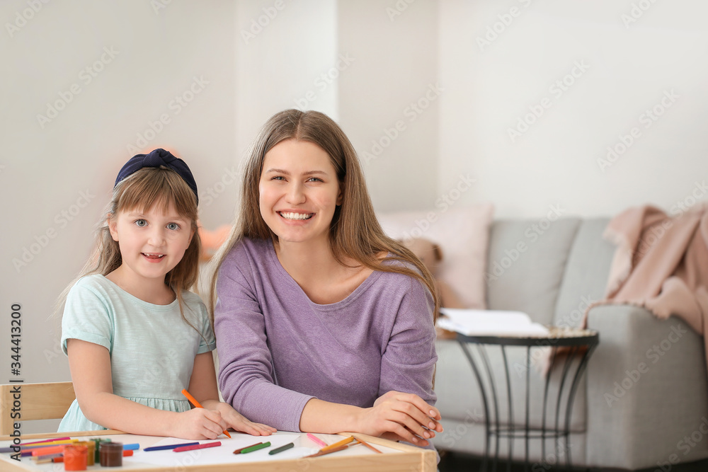Drawing teacher giving private art lessons to little girl at home Drawing teacher giving private art lessons to little girl at home