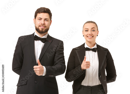 Male and female waiters showing thumb-up on white background