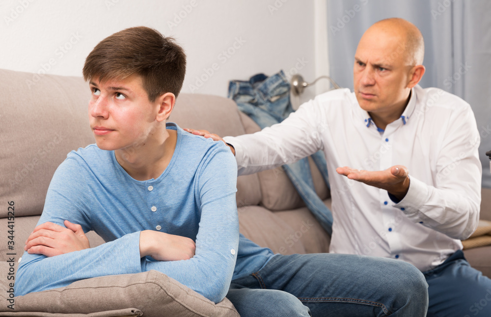 Man scolding son at home