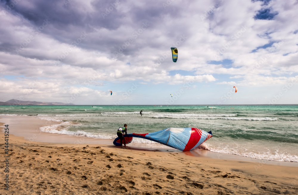 Kite surfing at Sotavento beach in Fuerteventura, Canary Islands, Spain Kite surfing at Sotavento beach in Fuerteventura, Canary Islands, Spain