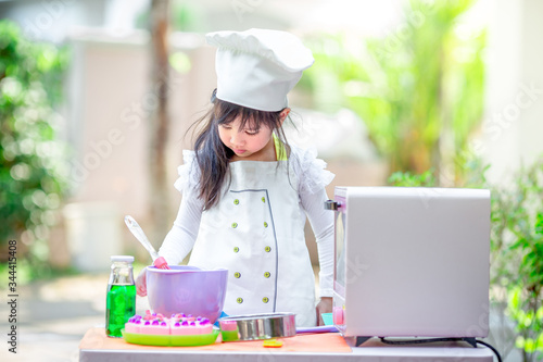 Close up background view Of cute young girls cooking desserts, with an oven and flour, cooking business concepts,learning models and marketing plans