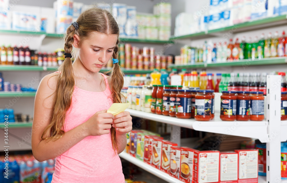 girl looking at shopping list