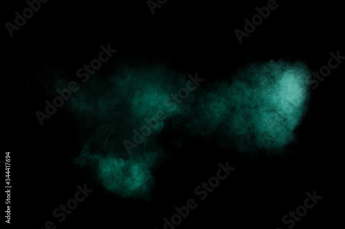 Aquamarine powder explosion on black background. Colored powder cloud. Colorful dust explode. Paint  Holi.