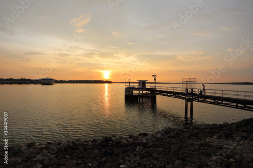 Fototapeta Naklejka Na Ścianę i Meble -  Dokkrai Reservoir and view sunset water reflection at rayong, thailand	
