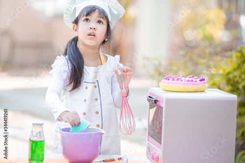 Close up background view Of cute young girls cooking desserts, with an oven and flour, cooking business concepts,learning models and marketing plans