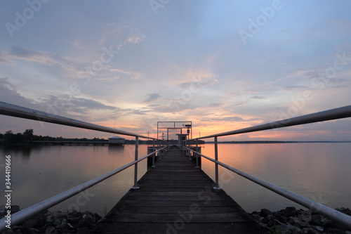 Fototapeta Naklejka Na Ścianę i Meble -  Dokkrai Reservoir and view sunset water reflection at rayong, thailand	