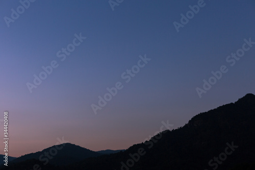 Sunset scene with silhouette mountain at Khun Dan Prakan Chon Dam