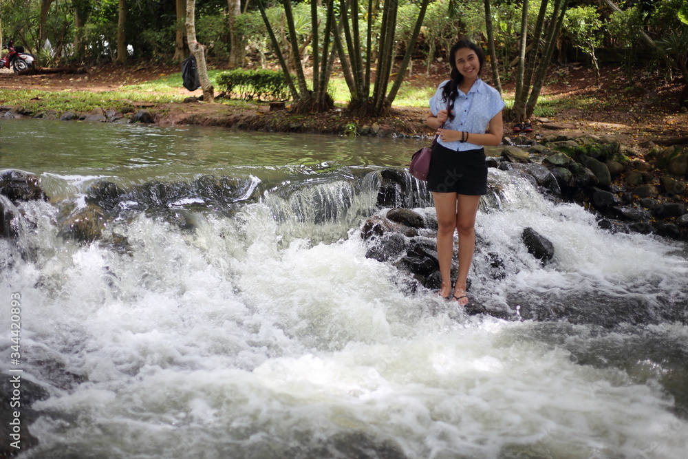Woman and Nam Tum waterfall in Chanthaburi at thailand Woman and Nam Tum waterfall in Chanthaburi at thailand