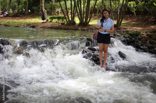 Woman and Nam Tum waterfall in Chanthaburi at thailand 