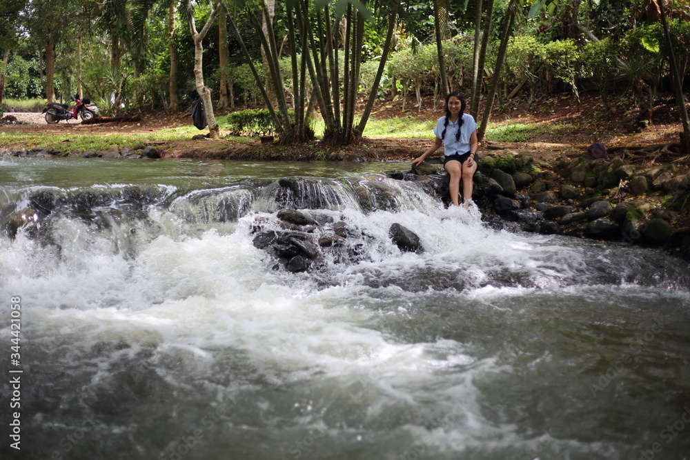 Woman and Nam Tum waterfall in Chanthaburi at thailand Woman and Nam Tum waterfall in Chanthaburi at thailand