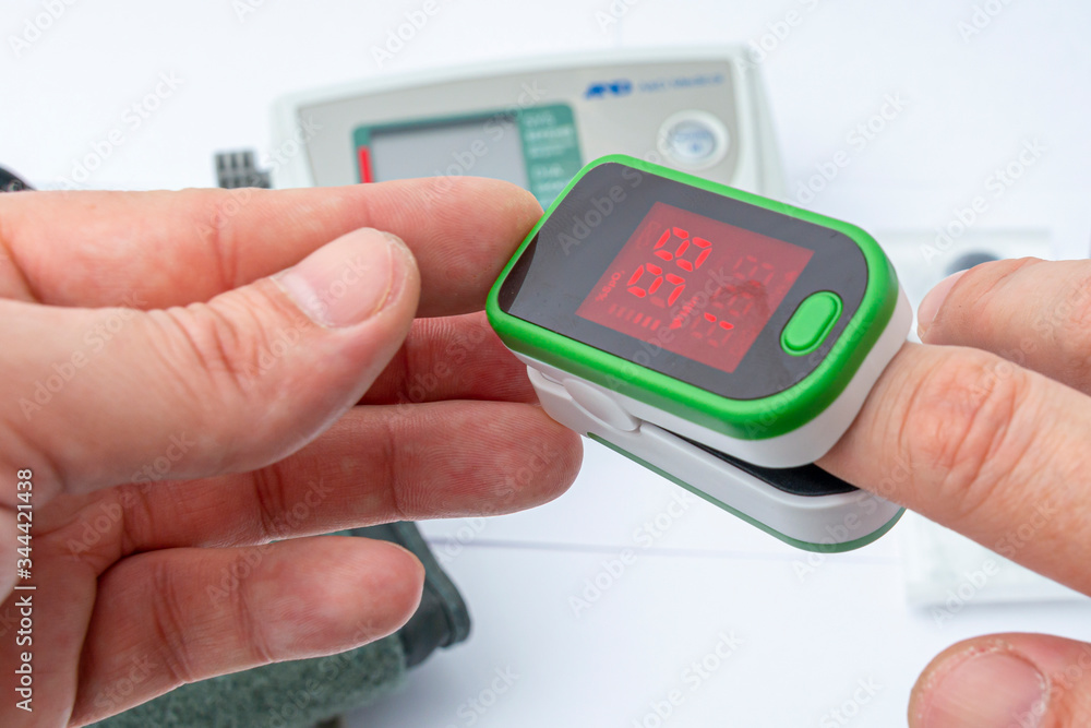 Pulse Oximeter, finger digital device to measure person`s oxygen saturation. Close-up. Reduced oxygenation is an emergency sign of pneumonia. Prevention and diagnosis of mers covid 19 Pulse Oximeter, finger digital device to measure person`s oxygen saturation. Close-up. Reduced oxygenation is an emergency sign of pneumonia. Prevention and diagnosis of mers covid 19