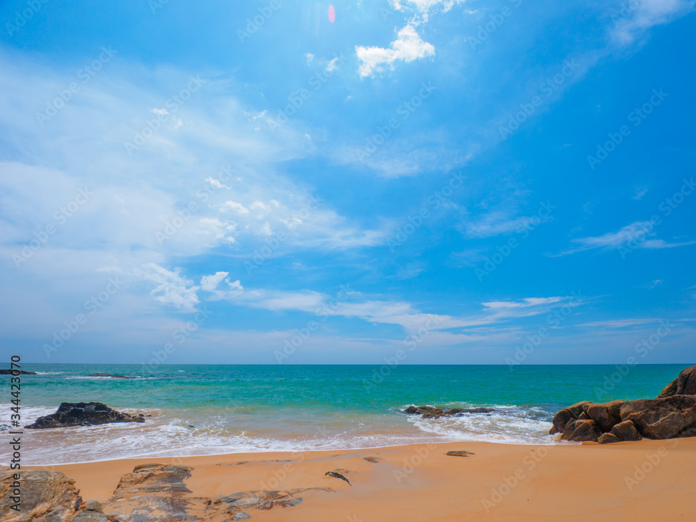 Uninhabited tropical beach with blue sky