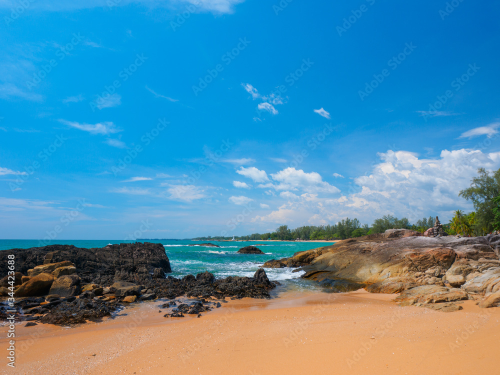 Uninhabited tropical rocky beach with blue sky