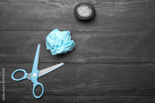 Scissors, rock and paper on wooden background photo