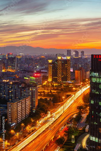 Warm sunset over a modern city with a lot of traffic