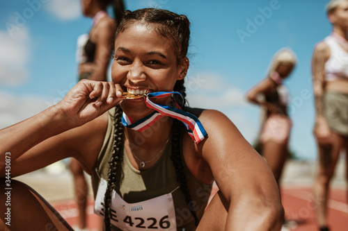 Runner looking excited after winning a medal photo