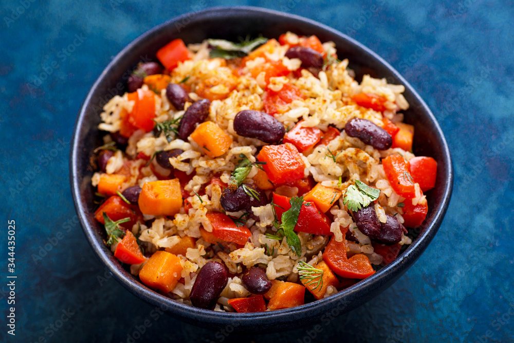 brown rice with vegetables on a blue background brown rice with vegetables on a blue background
