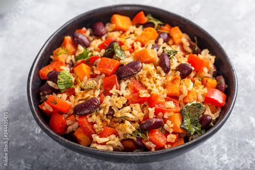 brown rice with vegetables on a grey background