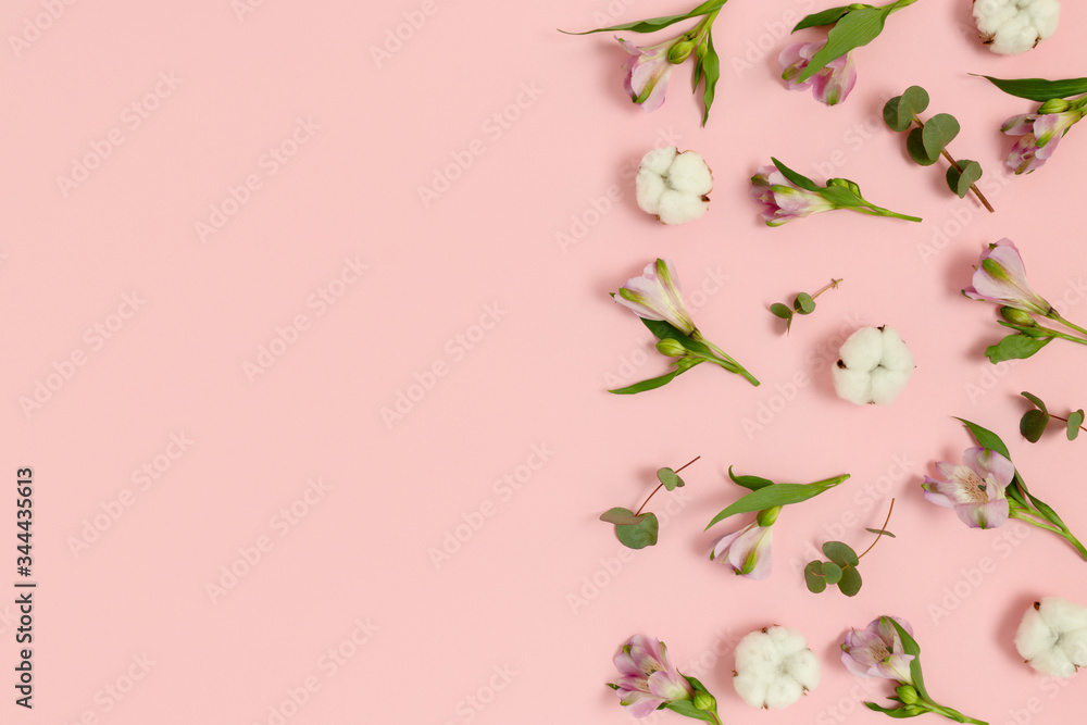 Pattern made of eucalyptus, cotton, alstroemeria flowers on a pink pastel background. Spring concept with copy space. Pattern made of eucalyptus, cotton, alstroemeria flowers on a pink pastel background. Spring concept with copy space.