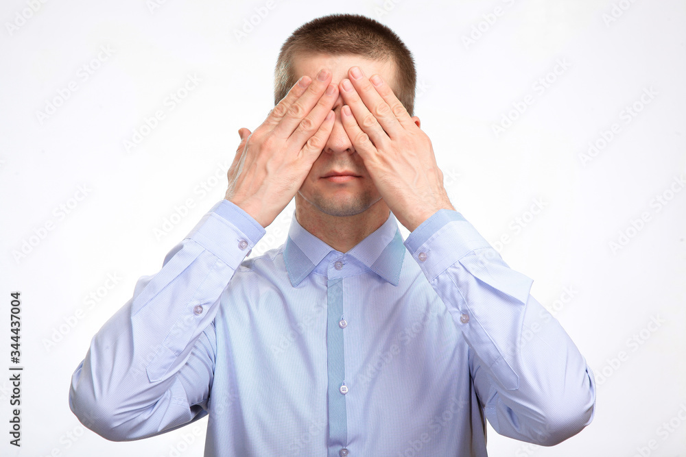 calm confident serious man closed his eyes to rest, in a blue light casual shirt. Isolated calm confident serious man closed his eyes to rest, in a blue light casual shirt. Isolated