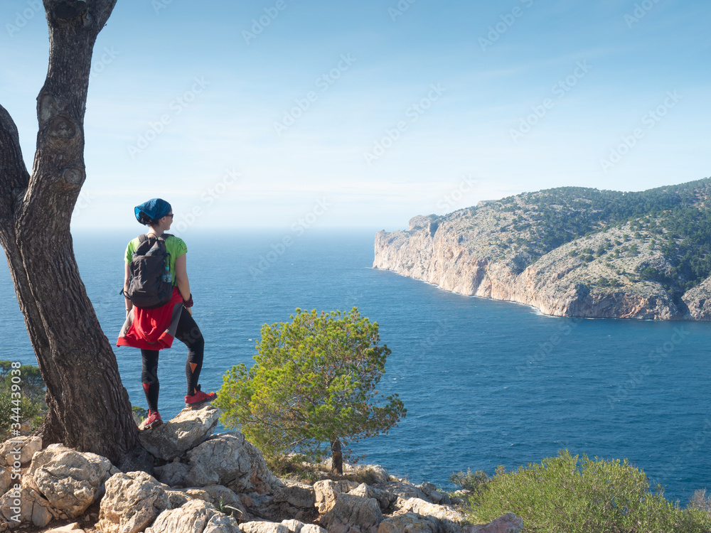 Mallorca shore mountain trail.  Woman enjoy island scenery, seascape of Mallorca, Spain