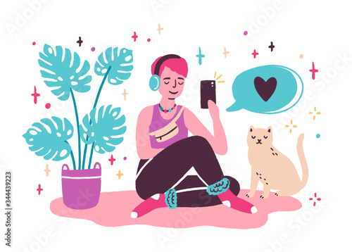 Young woman blogger sitting on the floor and taking selfie at home
