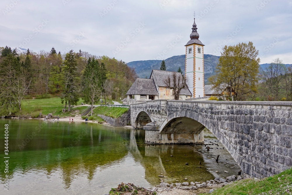 Church of St. John the Baptist in Ribcev Laz - Bohinj, Slovenia with a famous bridge Church of St. John the Baptist in Ribcev Laz - Bohinj, Slovenia with a famous bridge