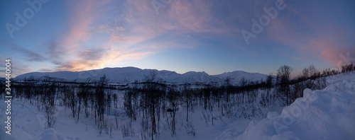 snowy and icy landscape in norway during winter in sunset