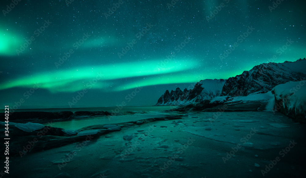 polar lights also called northern lights or aurora borealis in northern norway during winter above a fjord and snow covered mountains polar lights also called northern lights or aurora borealis in northern norway during winter above a fjord and snow covered mountains