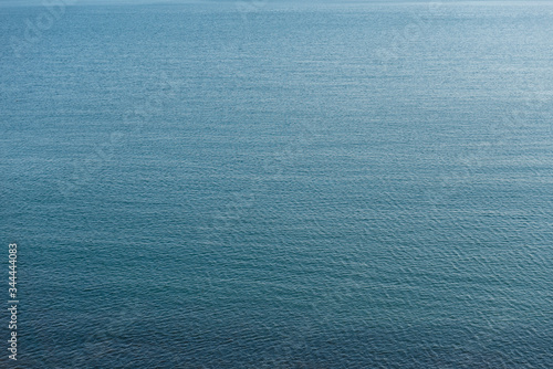 Calm sea. Natural dark blue water surface. Seascape abstract background. Arial view