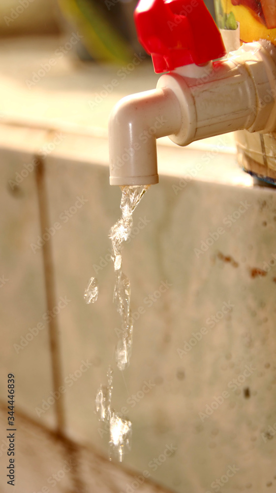 Unfocused, Noise, Blurry selective focus image white and red water taps that pour water, Unfocused, Noise, Blurry selective focus image white and red water taps that pour water,