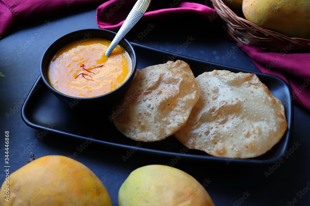 Indian Food Aamras is a sweet dish made from the pulp of the Alphonso mango fruit. Served with